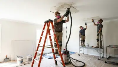 Tulsa, OK water damage restoration crew repairing a ceiling with stains and soaked drywall